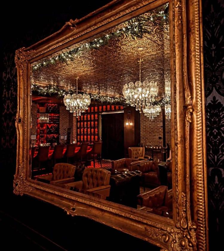 The lounge at Artemis, reflected in an ornate gold mirror